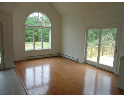 32 Warwick Road Orange, MA 01364 - Photo 4 of 11 a view of an empty room with wooden floor and a window