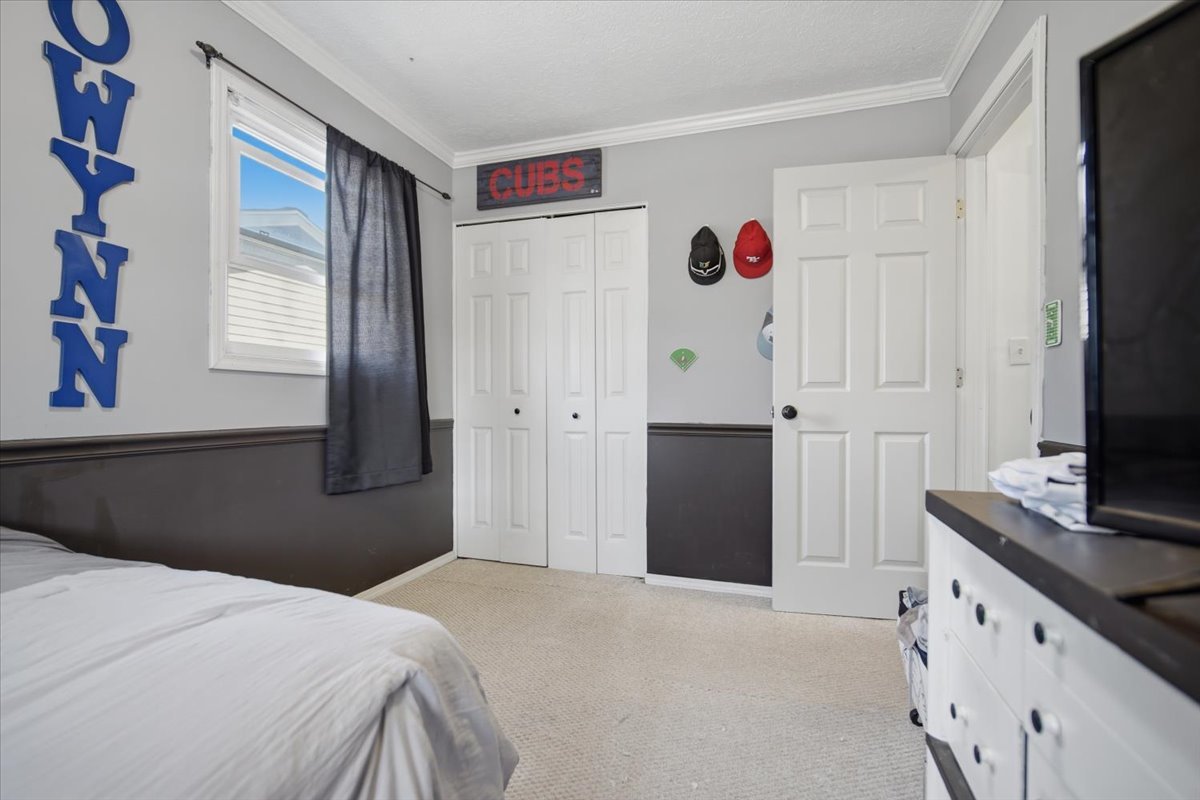 308 Columbia Drive Normal, IL 61761 - Photo 13 of 30 a bedroom with a bed and a flat screen tv