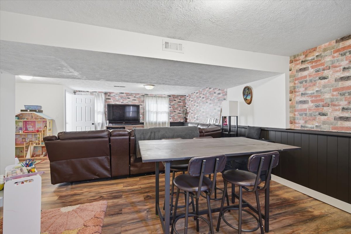 308 Columbia Drive Normal, IL 61761 - Photo 21 of 30 a view of a dining room with furniture and a flat screen tv