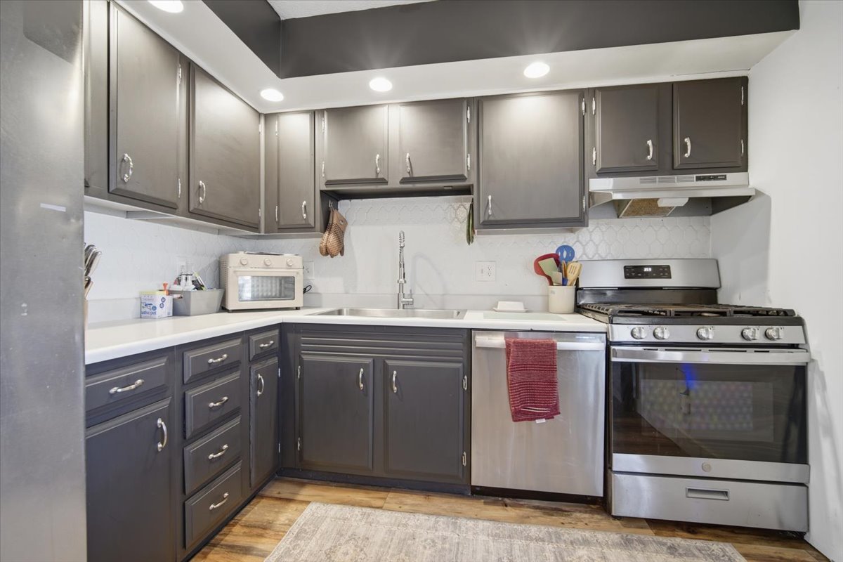 308 Columbia Drive Normal, IL 61761 - Photo 8 of 30 a kitchen with stainless steel appliances granite countertop a stove and a sink