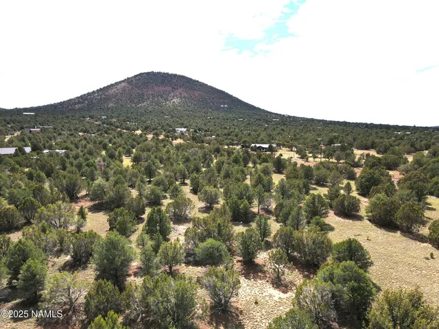 a view of a mountain range in a cloudy sky