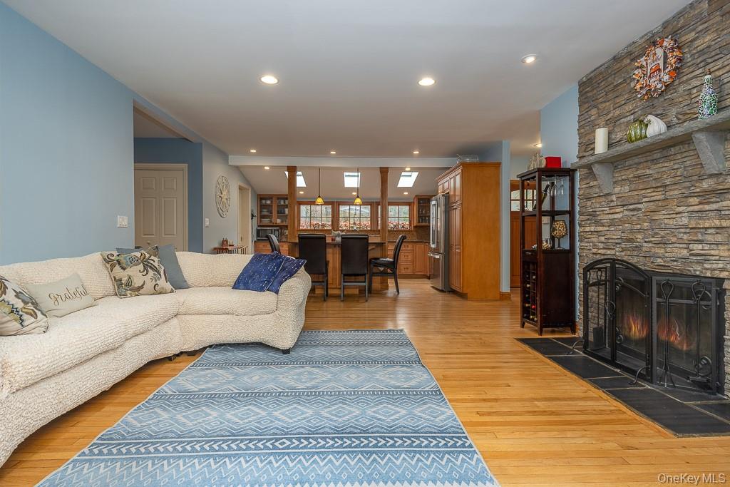 101 Hickory Hill Road Tappan, NY 10983 - Photo 11 of 40 a living room with furniture a dining table and a fireplace