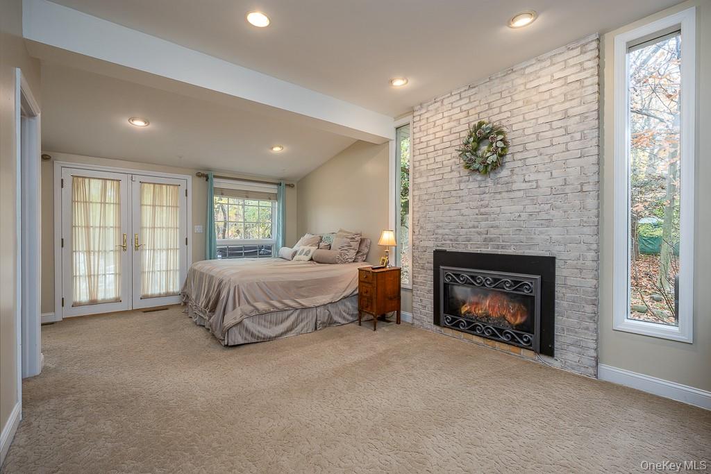 101 Hickory Hill Road Tappan, NY 10983 - Photo 15 of 40 a spacious bedroom with a bed and a fireplace