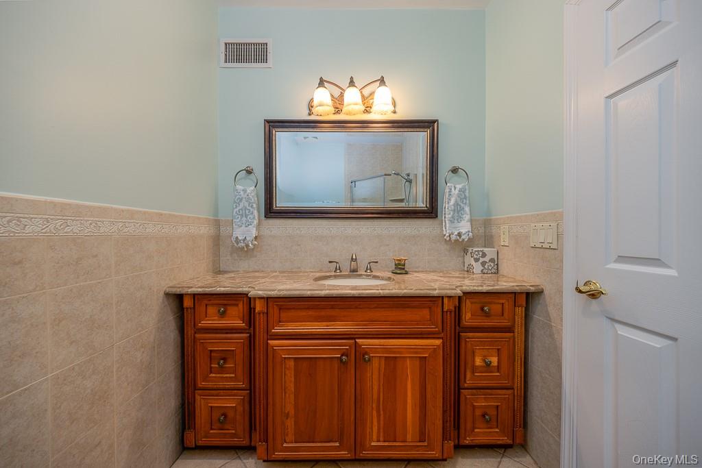 101 Hickory Hill Road Tappan, NY 10983 - Photo 16 of 40 a bathroom with a sink and a mirror