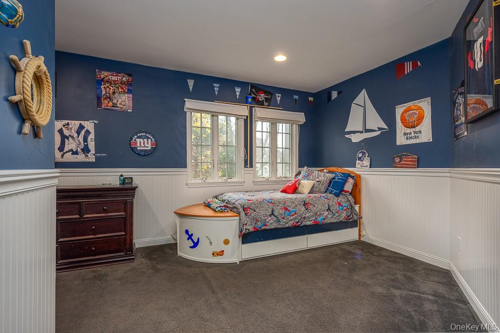 101 Hickory Hill Road Tappan, NY 10983 - Photo 17 of 40 a bedroom with bed and paintings on the wall