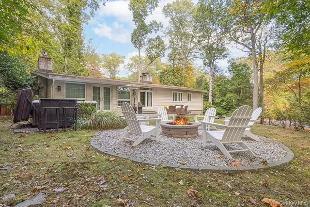 a view of a house with backyard porch and sitting area