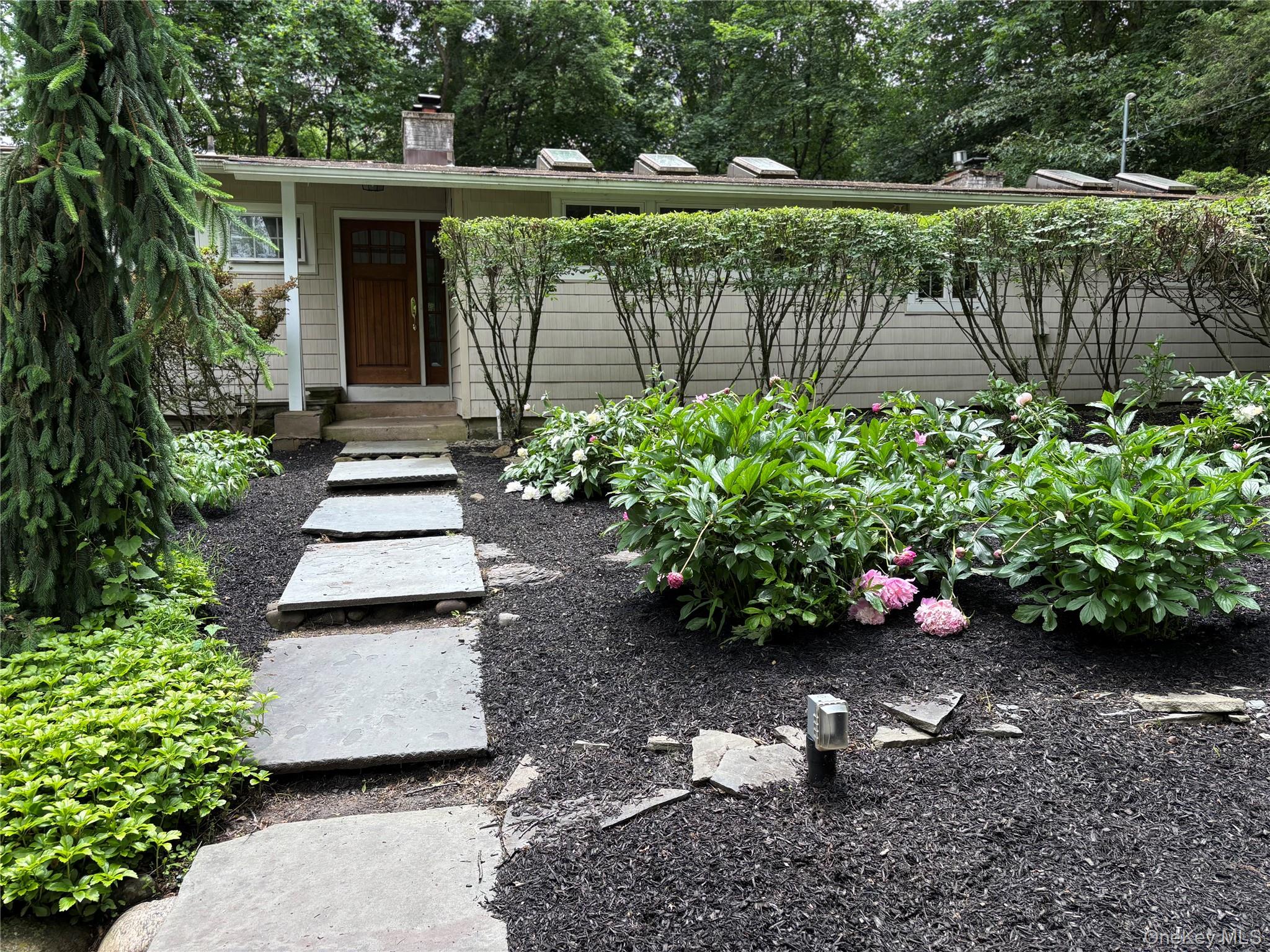 101 Hickory Hill Road Tappan, NY 10983 - Photo 34 of 40 a garden with trees in front of it