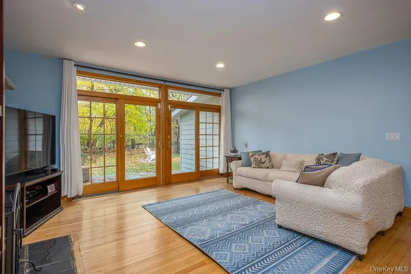 a living room with furniture a dining table and a fireplace