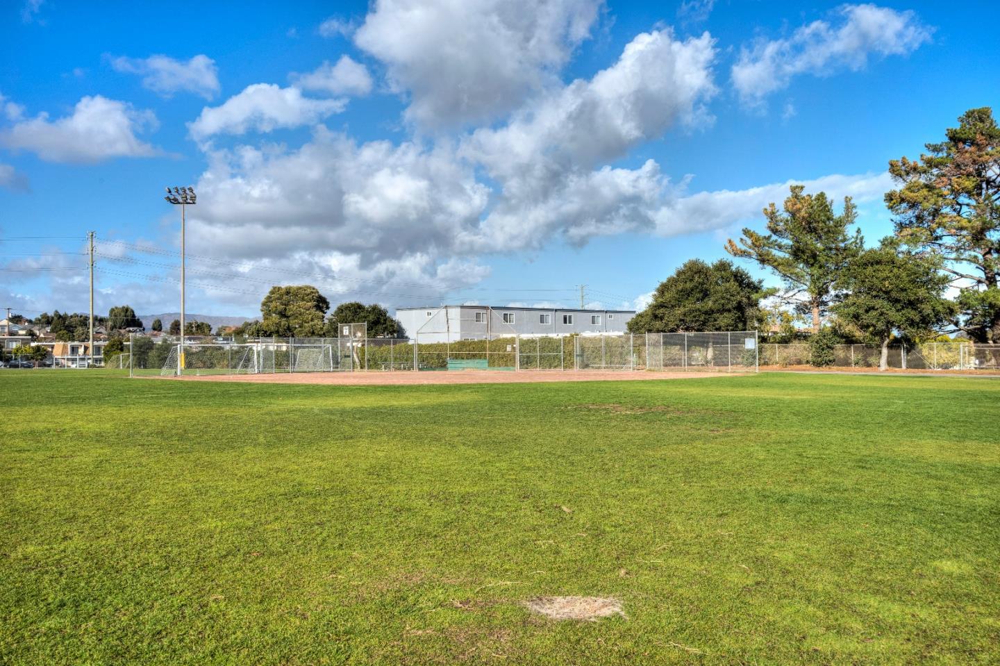 481 Lincoln Circle Millbrae, CA 94030 - Photo 23 of 24 a view of a fountain in front of a big yard with plants and large trees