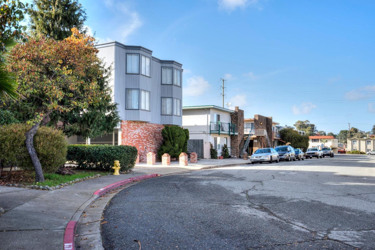 481 Lincoln Circle Millbrae, CA 94030 - Photo 3 of 24 a city street lined with buildings and trees