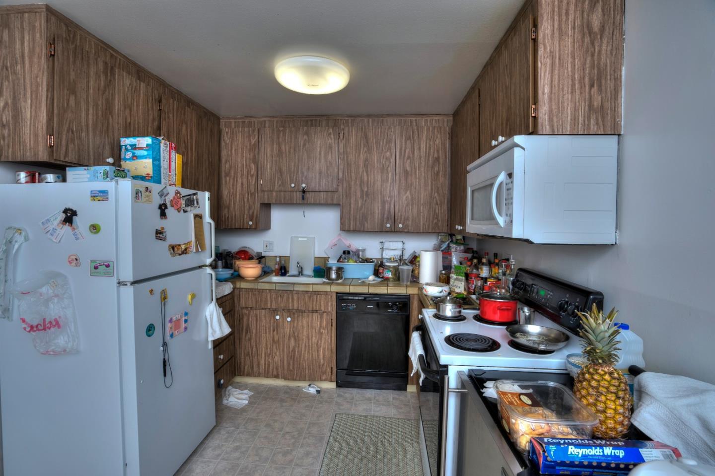481 Lincoln Circle Millbrae, CA 94030 - Photo 8 of 24 a kitchen with refrigerator and cabinets