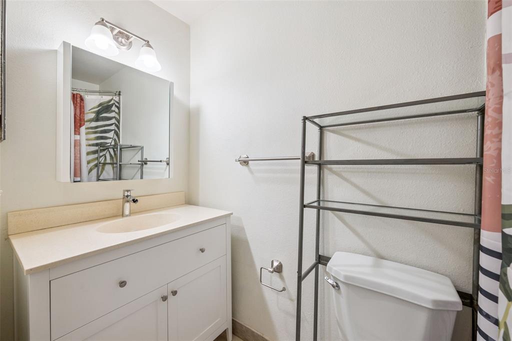 3032 Parkway Boulevard, Unit 305 Kissimmee, FL 34747 - Photo 16 of 40 a bathroom with a sink and a mirror