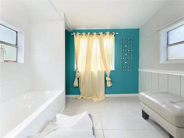 a spacious bathroom with a bathtub and shower