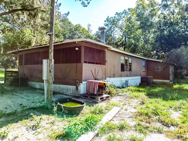 a view of a house with backyard porch and sitting area