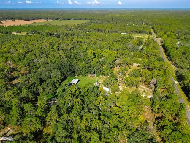 a view of a yard with an outdoor space and trees