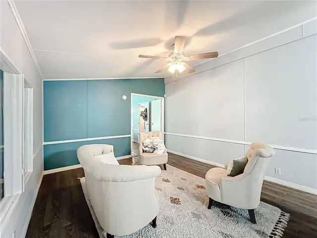 a living room with furniture and a ceiling fan
