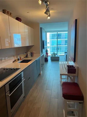a kitchen with sink cabinets and wooden floor