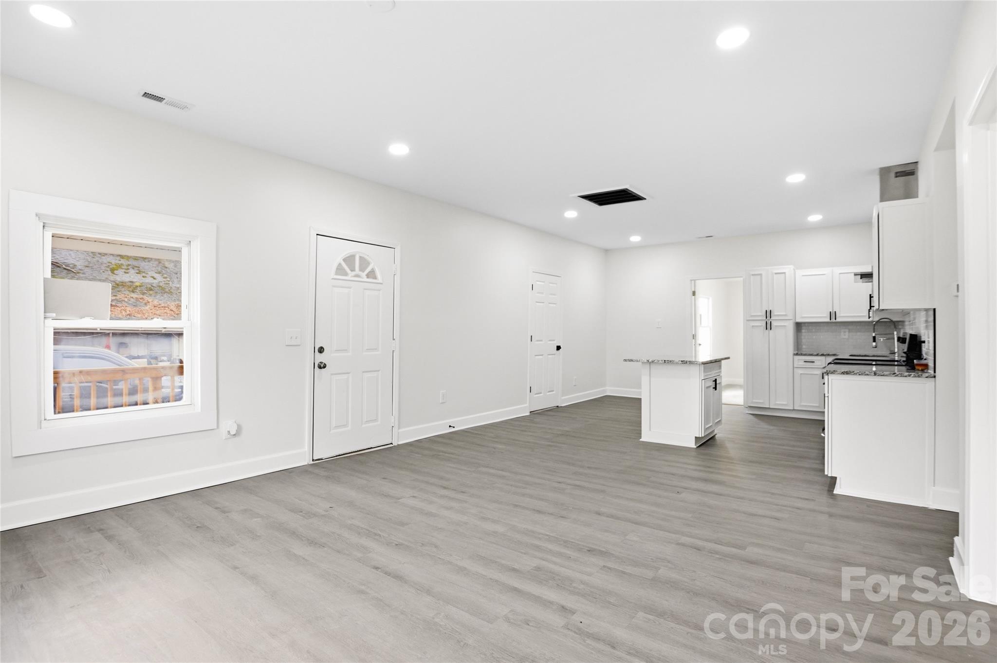 706 Sweeney Street Chester, SC 29706 - Photo 11 of 20 a view of kitchen with refrigerator and white cabinets