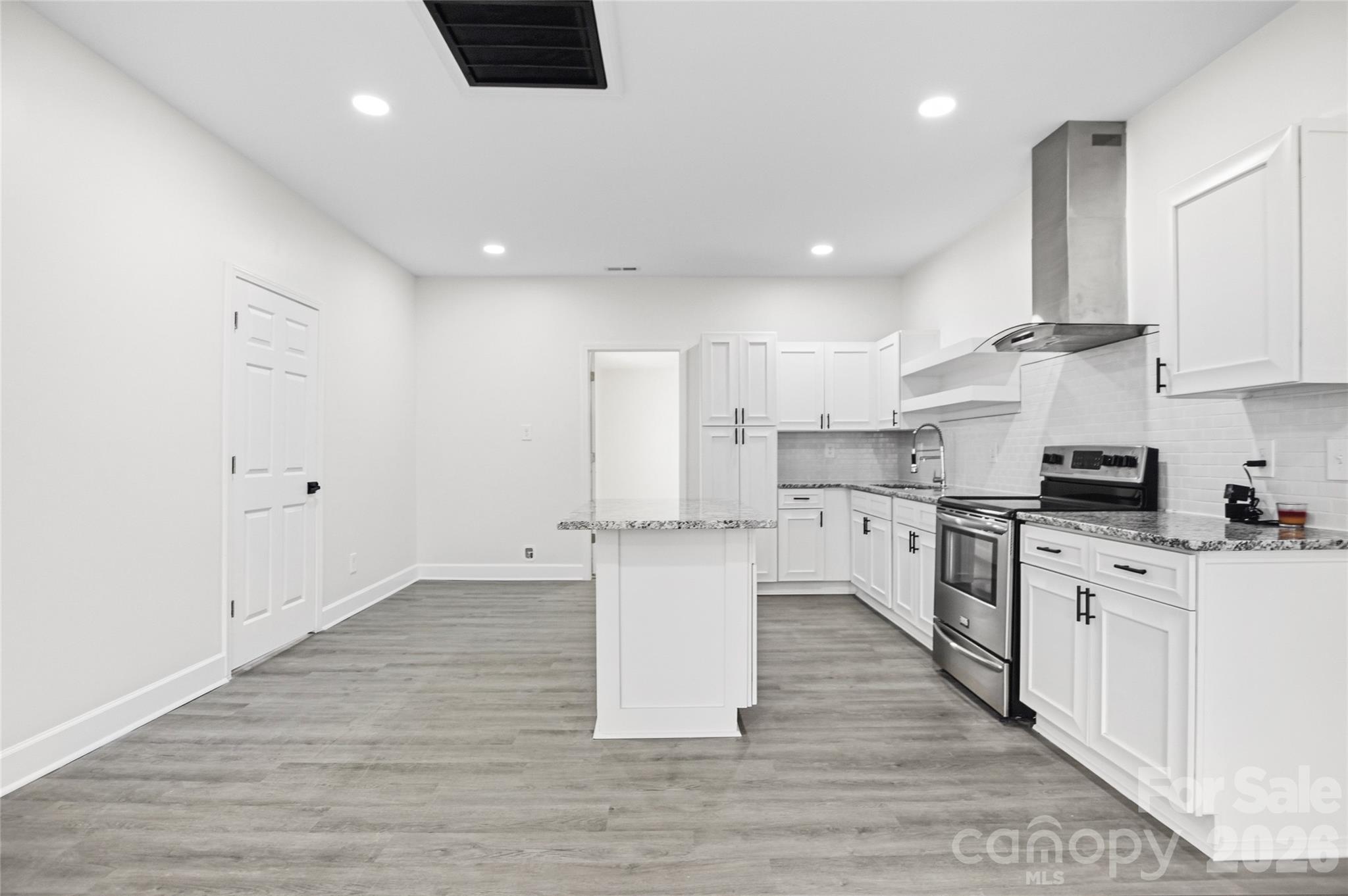 706 Sweeney Street Chester, SC 29706 - Photo 7 of 20 a kitchen with white cabinets and appliances