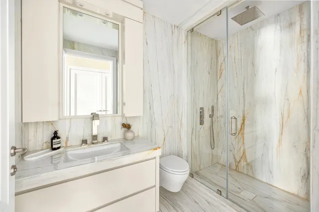a living room with furniture a large window and kitchen view