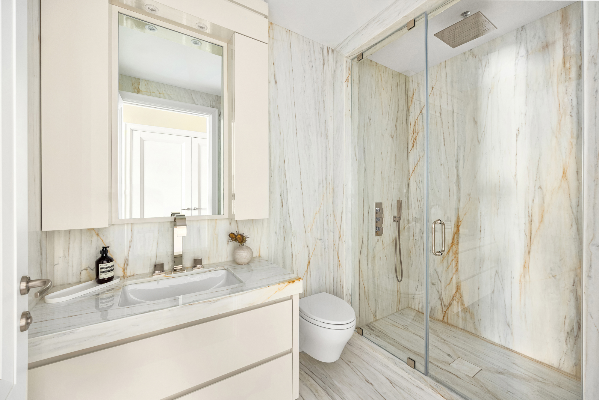 133 East 73rd Street, Unit PH Manhattan, NY 10021 - Photo 18 of 37 a bathroom with a granite countertop sink toilet and shower