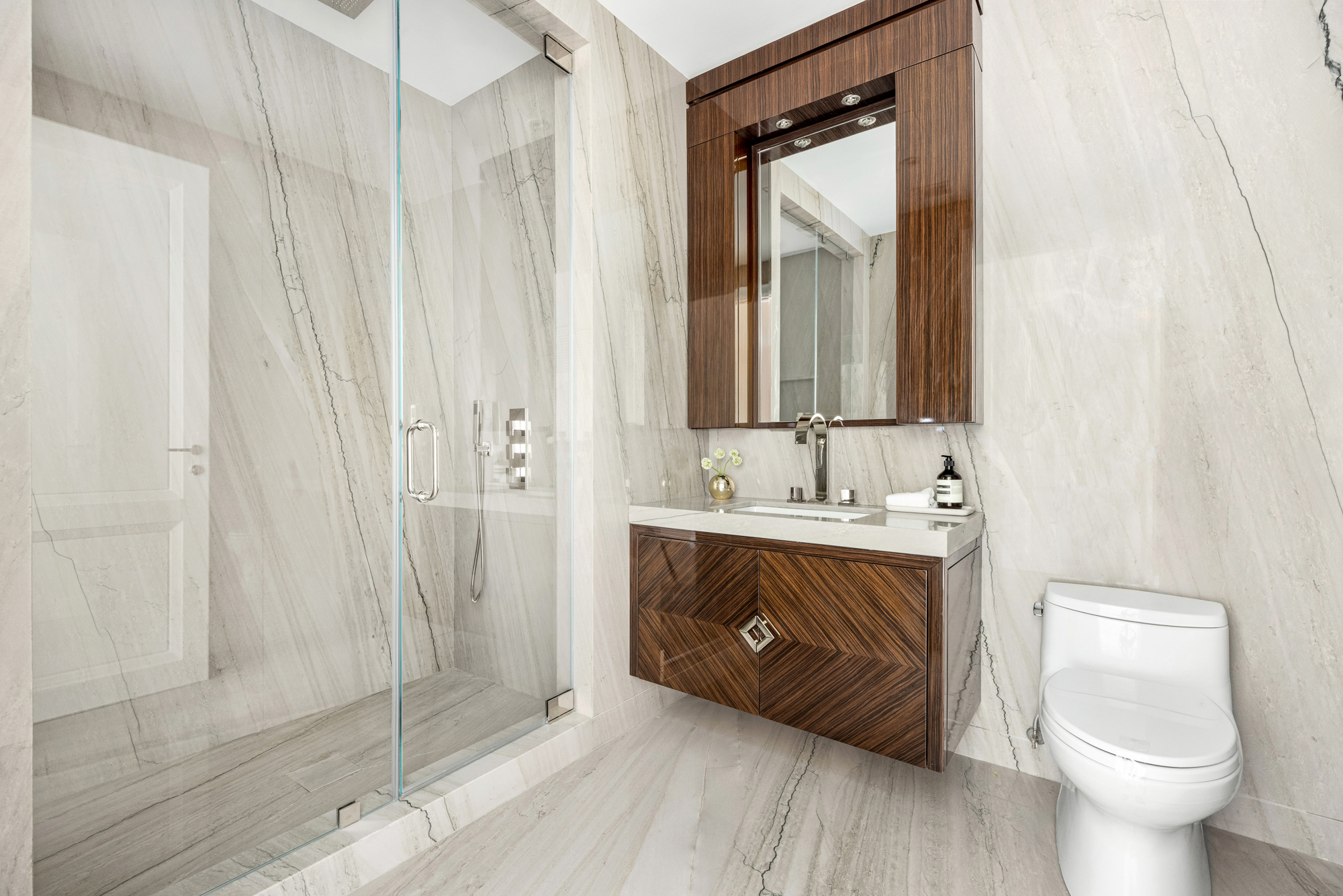 133 East 73rd Street, Unit PH Manhattan, NY 10021 - Photo 20 of 37 a bathroom with a toilet sink and mirror