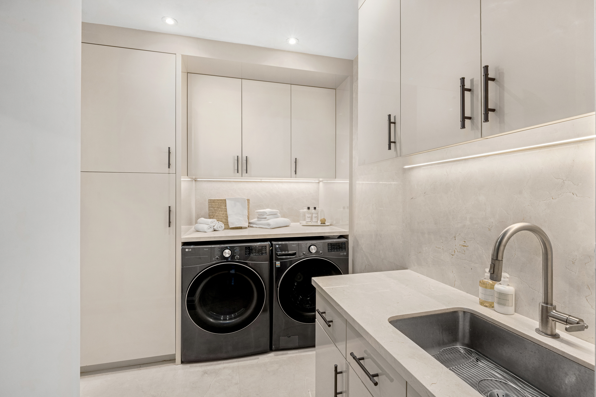 133 East 73rd Street, Unit PH Manhattan, NY 10021 - Photo 34 of 37 a utility room with sink dryer and washer
