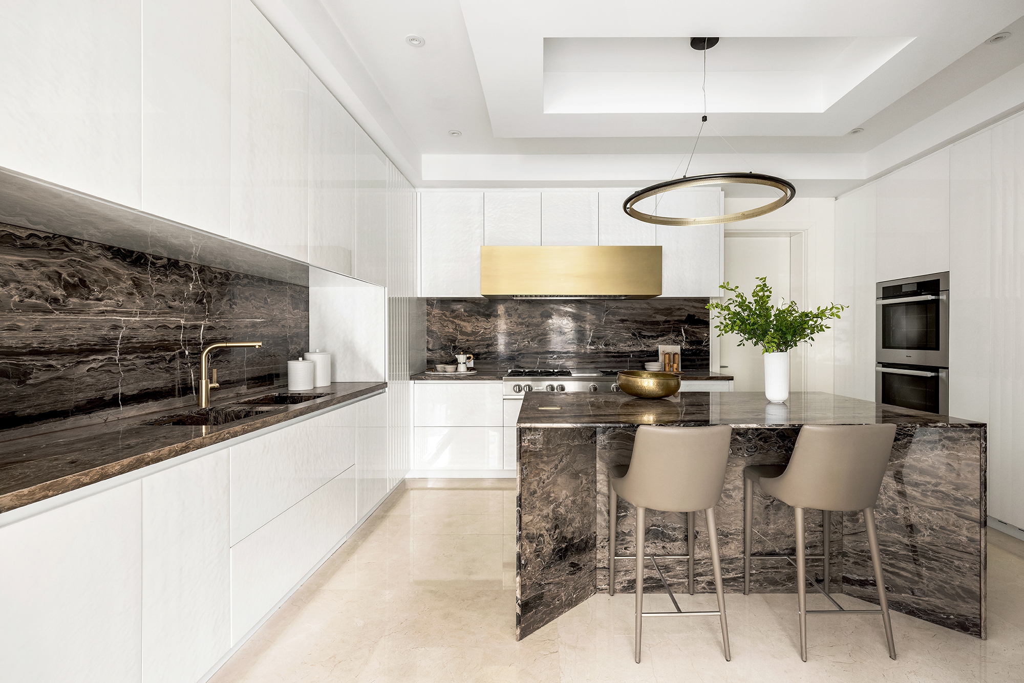 133 East 73rd Street, Unit PH Manhattan, NY 10021 - Photo 8 of 37 a kitchen with stainless steel appliances kitchen island granite countertop a sink and a stove