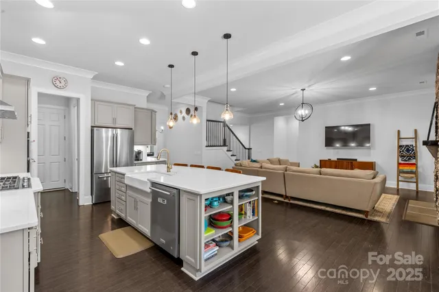 a large kitchen with stainless steel appliances kitchen island a large counter top and stove