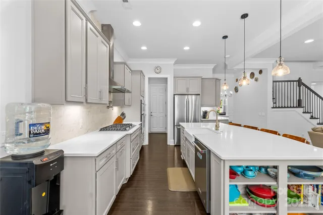 a kitchen that has a lot of cabinets and wooden floor