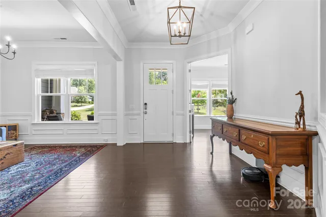 a view of an entryway with wooden floor and windows
