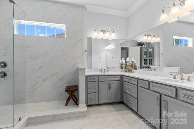 a spacious bathroom with a double vanity sink a mirror and a shower