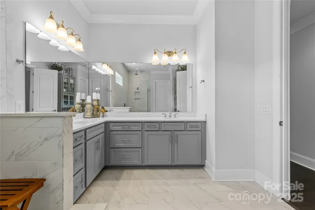 a spacious bathroom with a granite countertop sink a mirror and a vanity