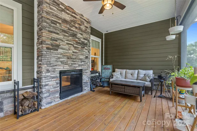 a view of a patio with couches and a fireplace