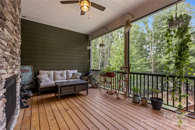 a view of a roof deck with wooden floor and outdoor seating