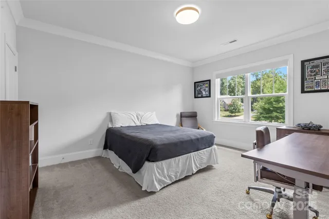 a bedroom with a bed and a desk