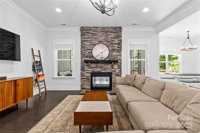 a living room with furniture a fireplace and a flat screen tv