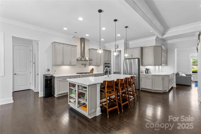 a large kitchen with a table and chairs in it