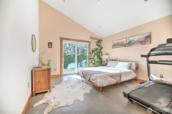 a bedroom with bed couch and window