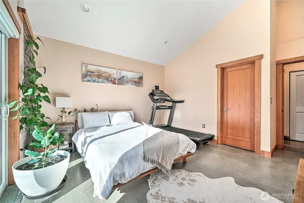 a bedroom with a bed and a potted plant