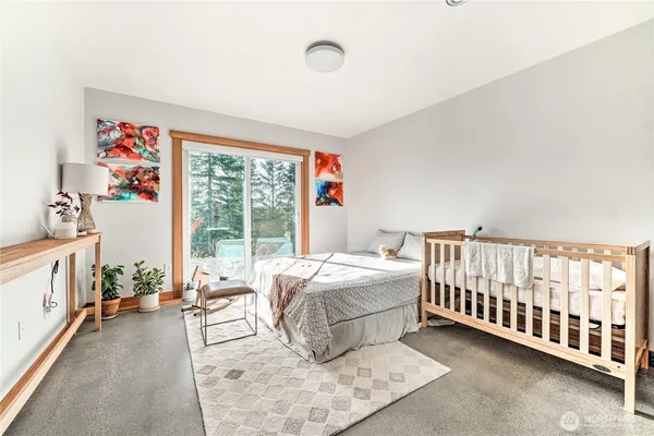 a bed room with a bed and a large window
