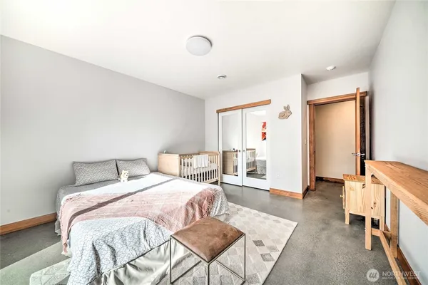 a bedroom with a bed and a couch