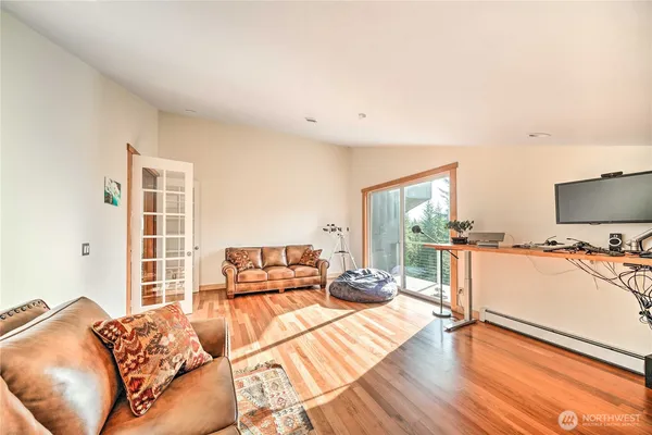a bedroom with furniture and a flat screen tv