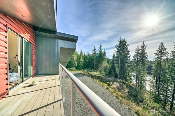 a view of balcony with wooden floor and fence