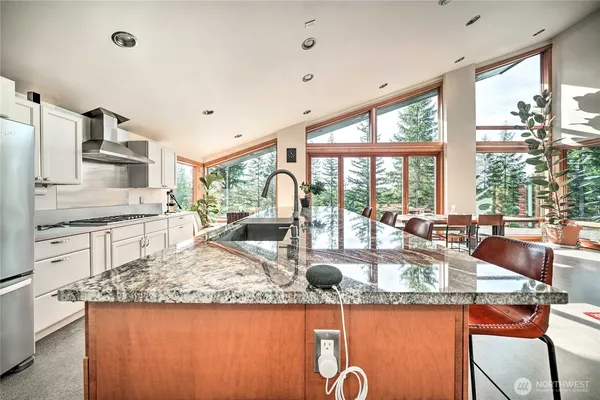 a kitchen with sink and view of living room
