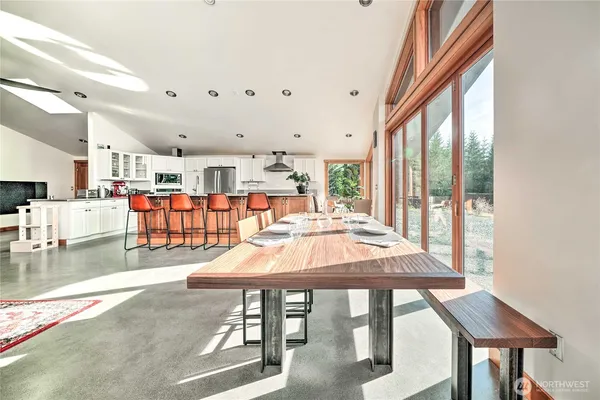a dining room with furniture a chandelier and wooden floor