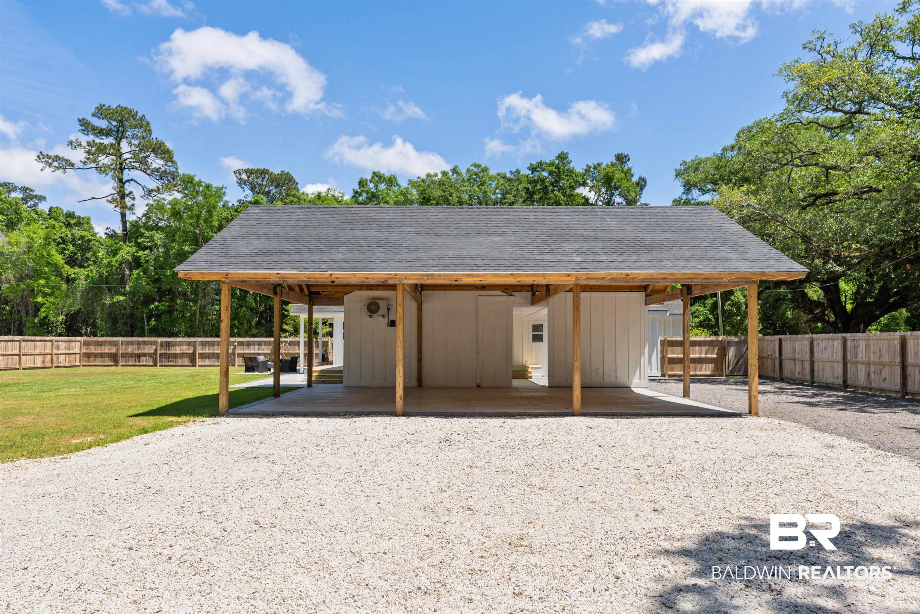 6447 Bemis Lane Bon Secour, AL 36511 - Photo 57 of 62 Attached carport featuring a gray shingle roof and natural wood support beams