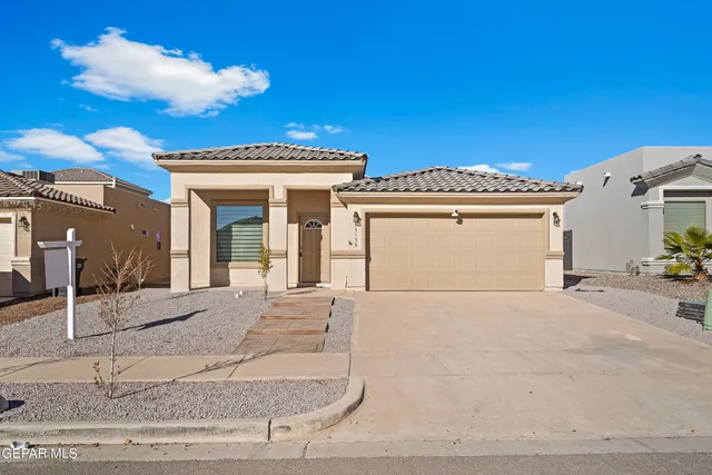 a view of a white house with a outdoor space