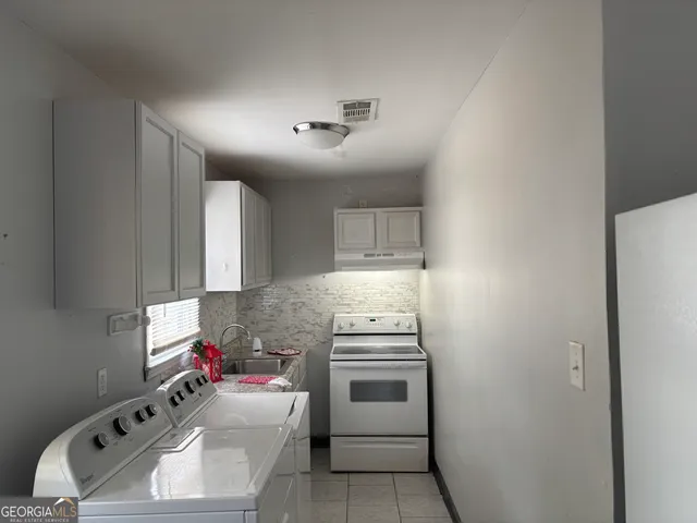 a kitchen with a stove and a refrigerator