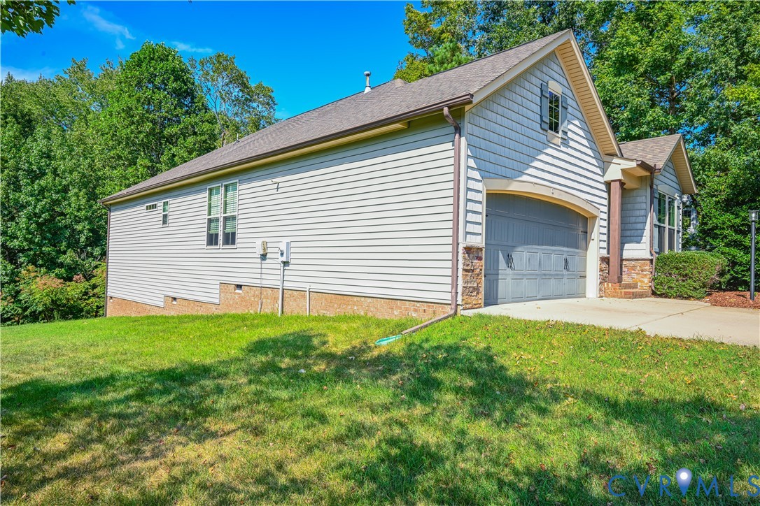 14536 Needham Market Road Midlothian, VA 23112 - Photo 24 of 25 Attached garage with an arched door, stone veneer